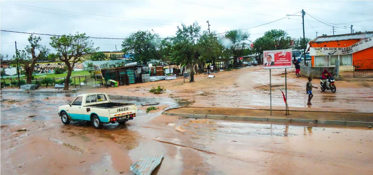 A car makes its way down a waterlogged street during floods in Maputo, Mozambique in 2013